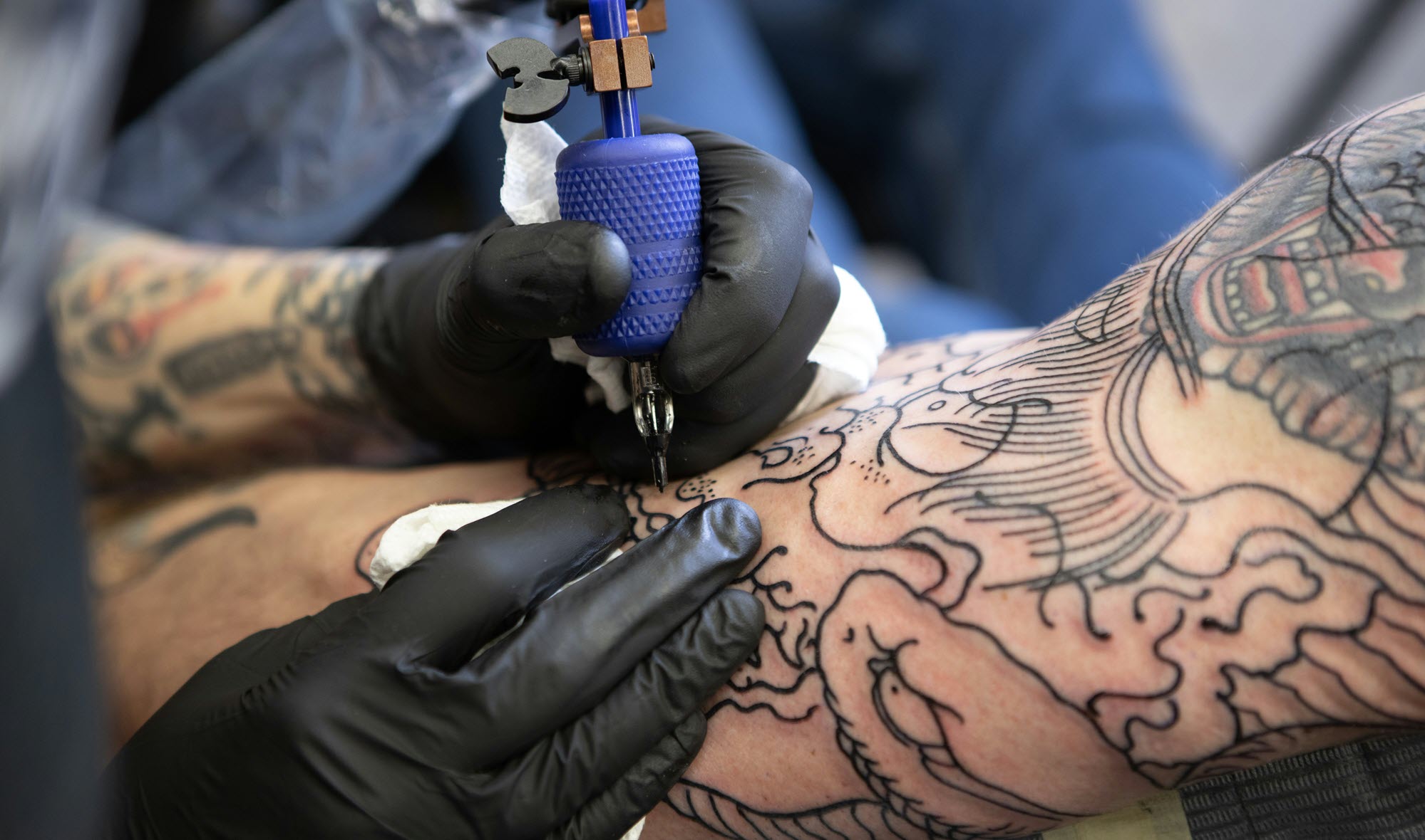 tattoo artist working
